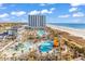 Aerial view of resort with pools, beach, and waterpark at 215 Baslow Ct. # 1-B, Myrtle Beach, SC 29572