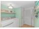 Bright laundry room with washer and dryer, and built-in shelving at 2511 S Ocean Blvd. # 1601, Myrtle Beach, SC 29577