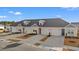 Three tan townhouses with garages and landscaping at 3518 Bells Lake Circle # 215, Longs, SC 29568
