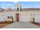 Two-story townhome with red door, attached garage, and landscaping at 3518 Bells Lake Circle # 215, Longs, SC 29568