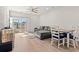 Open living area with L-shaped sofa, dining table, and sliding glass doors at 3518 Bells Lake Circle # 215, Longs, SC 29568