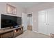 Bedroom with a large television, closet, and doorway to a hallway that allows easy access to other rooms at 421 Sunforest Way, Conway, SC 29526