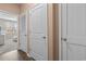 Hallway with several doors and hardwood floors, with a glimpse of a bright room in the background at 421 Sunforest Way, Conway, SC 29526