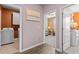Hallway with views into the laundry room, living room and bedroom, offering seamless flow at 421 Sunforest Way, Conway, SC 29526