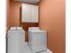 Functional laundry room with modern appliances, ample space and overhead storage cabinets at 421 Sunforest Way, Conway, SC 29526