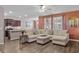 Open-concept living room with a sectional, hardwood floors, and a view into the kitchen at 421 Sunforest Way, Conway, SC 29526