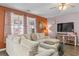 Cozy living room featuring a sectional, large windows, and stylish decor at 421 Sunforest Way, Conway, SC 29526