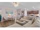 Bright living room with hardwood floors, a large sectional sofa, and an adjacent kitchen at 421 Sunforest Way, Conway, SC 29526