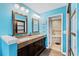 Bathroom with double vanity, tile floors, large mirrors, and an open door to the tub at 4396 Baldwin Ave. # 34, Little River, SC 29566
