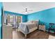 Bedroom with blue walls, a ceiling fan, a light-colored bed frame, and hardwood floors at 4396 Baldwin Ave. # 34, Little River, SC 29566