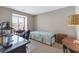 Spare bedroom with large window, desk, and twin bed at 4396 Baldwin Ave. # 34, Little River, SC 29566
