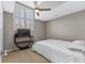 Neutral bedroom with ceiling fan, a large window with shutter blinds, and clean white bedding at 4396 Baldwin Ave. # 34, Little River, SC 29566