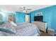 Bedroom with bright blue walls, ceiling fan, and light-colored furniture at 4396 Baldwin Ave. # 34, Little River, SC 29566