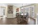 Bright dining area featuring a wood table, views of the kitchen, and hardwood-style floors at 4396 Baldwin Ave. # 34, Little River, SC 29566