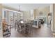 A dining area with a table set for eight, surrounded by bay windows and wood floors at 4396 Baldwin Ave. # 34, Little River, SC 29566