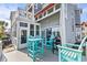Back patio with teal furniture, awning, screened-in porch, and gray wood shingle siding at 4396 Baldwin Ave. # 34, Little River, SC 29566