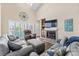 Inviting living room offers ample seating, a fireplace, and views of the outdoor scenery through large windows at 4396 Baldwin Ave. # 34, Little River, SC 29566