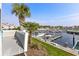 Elevated view of a marina with boats docked, framed by palm trees and gray wood shingle siding at 4396 Baldwin Ave. # 34, Little River, SC 29566