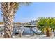 Waterfront view of the marina from the house, framed by palm trees and boats at 4396 Baldwin Ave. # 34, Little River, SC 29566