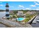 Aerial view of Lighthouse Village, including pool, marina, and lighthouse at 4641 Lightkeepers Way # 3A, Little River, SC 29566