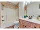 Bathroom with tub, shower, wood vanity and updated flooring at 4641 Lightkeepers Way # 3A, Little River, SC 29566