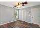 Bright bedroom with ceiling fan, double closet and wood-look flooring at 4641 Lightkeepers Way # 3A, Little River, SC 29566