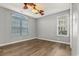Spacious bedroom with ceiling fan, wood-look flooring, and neutral walls at 4641 Lightkeepers Way # 3A, Little River, SC 29566