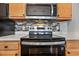 Stainless steel appliances and wood cabinets in this kitchen at 4641 Lightkeepers Way # 3A, Little River, SC 29566