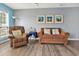 Bright living room with hardwood floors, comfy seating, and large windows at 4641 Lightkeepers Way # 3A, Little River, SC 29566