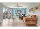 Spacious living room featuring hardwood floors, a ceiling fan, and sliding glass doors at 4641 Lightkeepers Way # 3A, Little River, SC 29566