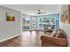 Living room with hardwood floors, a ceiling fan, and sliding glass doors at 4641 Lightkeepers Way # 3A, Little River, SC 29566