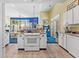 Kitchen with island, white cabinets, and stainless steel appliances at 5019 Gilbert Ln., North Myrtle Beach, SC 29582