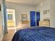 Bright bedroom featuring a comfortable blue quilted bedspread and ensuite bathroom at 502 Castellar Ln., Little River, SC 29566