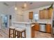 Modern kitchen features stainless steel appliances, granite countertops, and a breakfast bar with barstools at 502 Castellar Ln., Little River, SC 29566