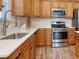 Modern kitchen features stainless steel appliances, granite countertops, and ample cabinet space for cooking at 502 Castellar Ln., Little River, SC 29566