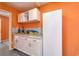 Functional laundry room featuring white cabinets, a granite countertop, and a tiled backsplash at 502 Castellar Ln., Little River, SC 29566