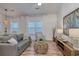 Bright living room with a gray sofa, stylish decor, and lots of natural light at 502 Castellar Ln., Little River, SC 29566