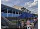 Outdoor waterfront dining on a covered deck with a blue umbrella offers a refreshing and relaxing experience at 502 Castellar Ln., Little River, SC 29566