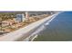 Picturesque aerial capturing coastline, showing beachside condos and hotels with clear blue ocean views at 5511 N Ocean Blvd. # 302, Myrtle Beach, SC 29577