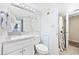 Well-lit bathroom with white vanity, toilet, and a shower with a decorative shower curtain at 5511 N Ocean Blvd. # 302, Myrtle Beach, SC 29577