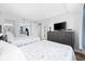 Bedroom featuring two beds, a dresser with a TV, and a closet with mirrored doors at 5511 N Ocean Blvd. # 302, Myrtle Beach, SC 29577