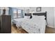 Bright bedroom featuring two beds, a window with a view, and wood-look flooring at 5511 N Ocean Blvd. # 302, Myrtle Beach, SC 29577