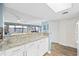 Open kitchen with granite countertops, white cabinets and appliances that overlooks the spacious living area at 5511 N Ocean Blvd. # 302, Myrtle Beach, SC 29577