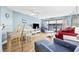 Comfortable living room featuring contemporary furnishings, light blue walls, ceiling fan, and sliding glass doors to balcony at 5511 N Ocean Blvd. # 302, Myrtle Beach, SC 29577