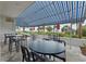 Picturesque outdoor seating area covered by blue awning, providing a charming and comfortable space for residents to enjoy the fresh air at 5511 N Ocean Blvd. # 302, Myrtle Beach, SC 29577