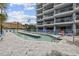 Modern condo building with a unique pool and deck chairs, offering residents a luxurious outdoor space to relax and soak up the sun at 5511 N Ocean Blvd. # 302, Myrtle Beach, SC 29577