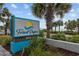 Community sign for Forest Dunes with palm trees and landscaping near the beach at 5511 N Ocean Blvd. # 302, Myrtle Beach, SC 29577
