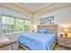 Main bedroom with a king-size bed, large windows, and wood-look flooring at 6015 Catalina Dr. # 431, North Myrtle Beach, SC 29582