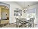 Dining area with a rustic table, chandelier, and access to kitchen and living room at 6015 Catalina Dr. # 431, North Myrtle Beach, SC 29582