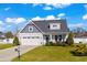 Two-story craftsman style home with gray siding, two-car garage, and landscaped lawn at 626 Notting Hill Ct., Conway, SC 29526